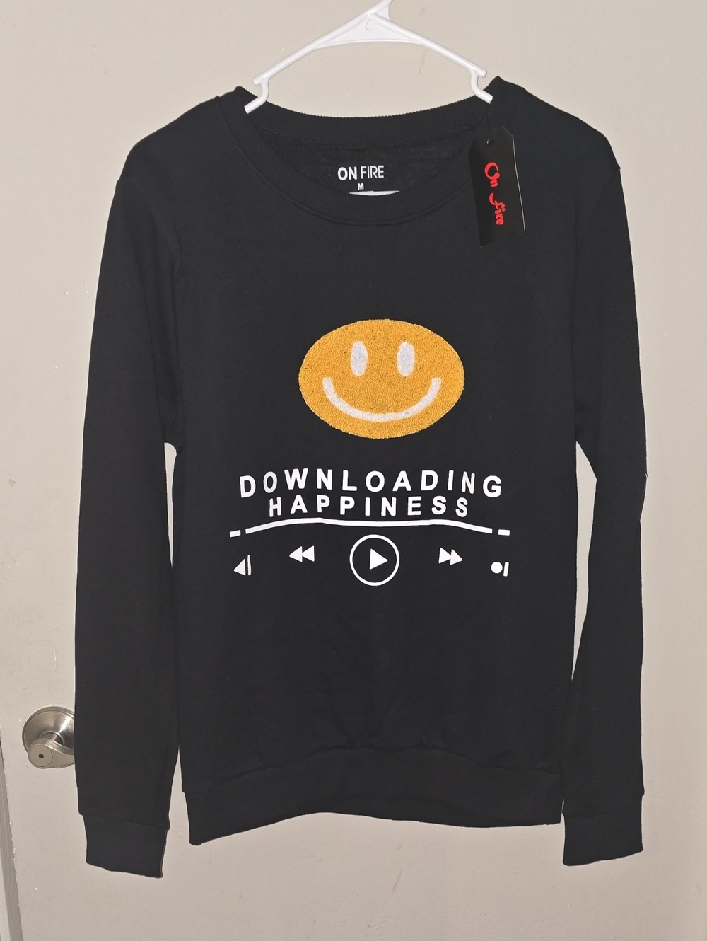On Fire Black Crewneck Sweater with Yellow Smiley Graphic and White Text